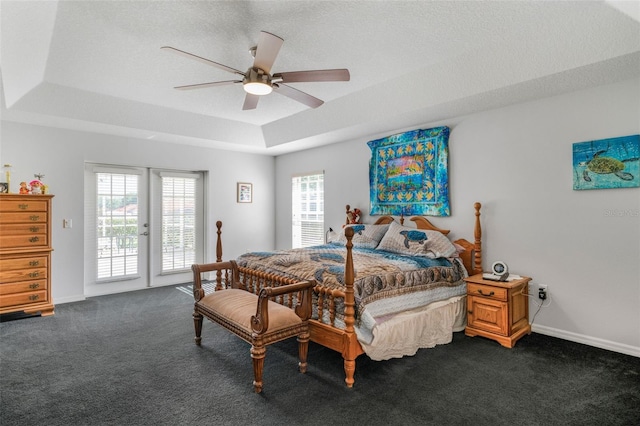 4277 E Bennett St, Inverness, FL 34453 - bedroom with dark colored carpet, access to exterior, a tray ceiling, and a ceiling fan