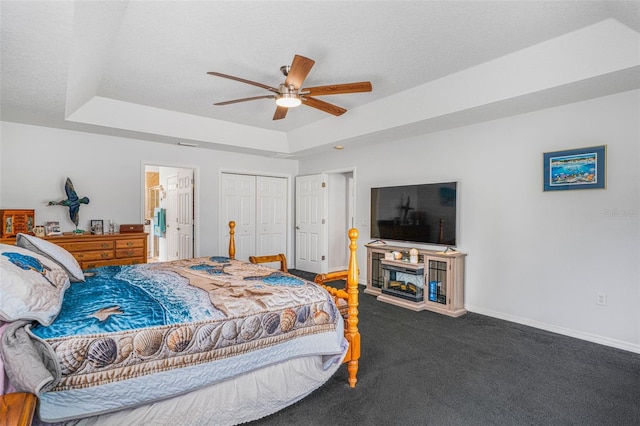 4277 E Bennett St, Inverness, FL 34453 - carpeted bedroom with a closet, baseboards, ensuite bathroom, a fireplace, and a tray ceiling