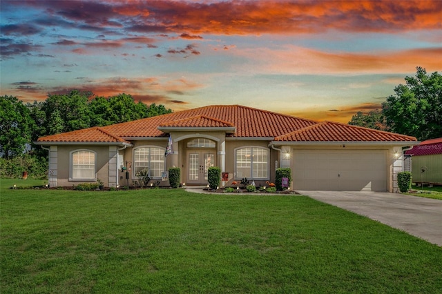 4277 E Bennett St, Inverness, FL 34453 - mediterranean / spanish house featuring a tiled roof, driveway, a garage, and a front yard