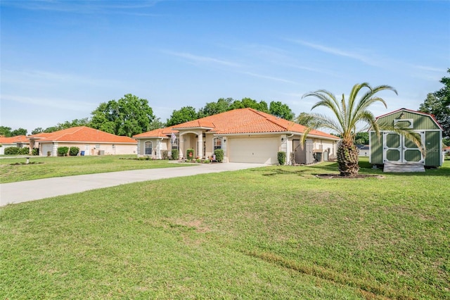 4277 E Bennett St, Inverness, FL 34453 - mediterranean / spanish-style home featuring a front yard, a tiled roof, a garage, a storage unit, and driveway
