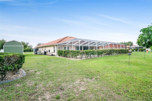 4277 E Bennett St, Inverness, FL 34453 - back of house featuring a yard, stucco siding, and glass enclosure