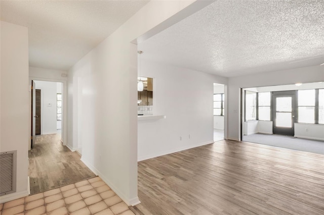 4401 E Windmill Dr, Inverness, FL 34453 - interior space with a textured ceiling, wood finished floors, baseboards, and visible vents