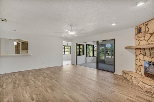 4401 E Windmill Dr, Inverness, FL 34453 - unfurnished living room with visible vents, a textured ceiling, and wood finished floors