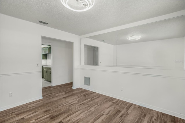 4401 E Windmill Dr, Inverness, FL 34453 - unfurnished room featuring visible vents, a textured ceiling, and wood finished floors