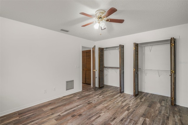 4401 E Windmill Dr, Inverness, FL 34453 - unfurnished bedroom with visible vents, baseboards, two closets, and wood finished floors