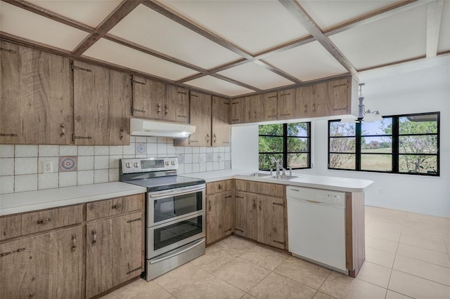 4401 E Windmill Dr, Inverness, FL 34453 - kitchen with backsplash, under cabinet range hood, dishwasher, range with two ovens, and a sink