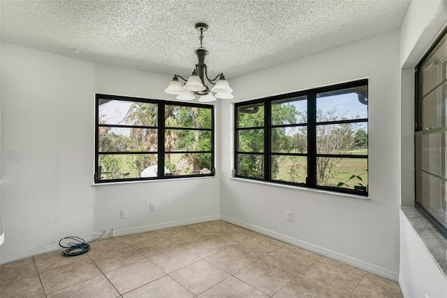 4401 E Windmill Dr, Inverness, FL 34453 - empty room featuring tile patterned flooring, a notable chandelier, a textured ceiling, and baseboards