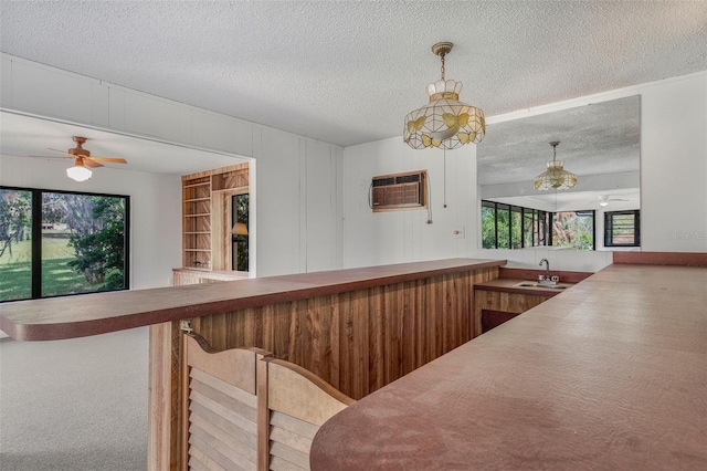 4401 E Windmill Dr, Inverness, FL 34453 - bar with indoor wet bar, a textured ceiling, a wall unit AC, a sink, and plenty of natural light