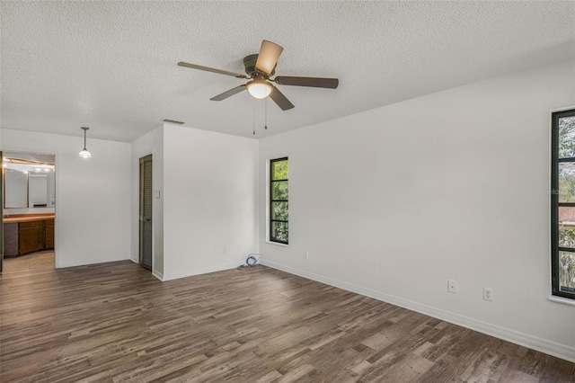 4401 E Windmill Dr, Inverness, FL 34453 - unfurnished room with a textured ceiling, a ceiling fan, wood finished floors, and a healthy amount of sunlight