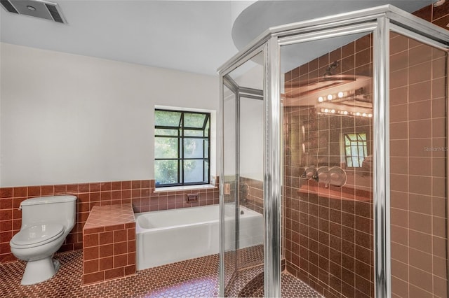 4401 E Windmill Dr, Inverness, FL 34453 - full bath with tile patterned flooring, toilet, a shower stall, visible vents, and tile walls