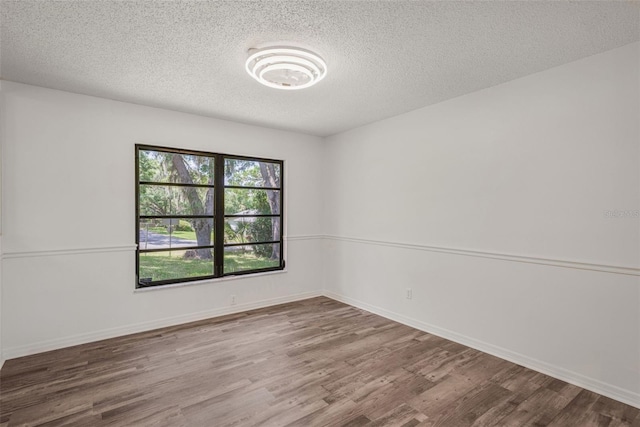4401 E Windmill Dr, Inverness, FL 34453 - spare room featuring a textured ceiling, wood finished floors, and baseboards