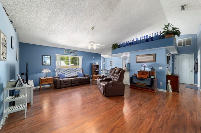 living area featuring a textured ceiling, wood finished floors, a ceiling fan, and visible vents
