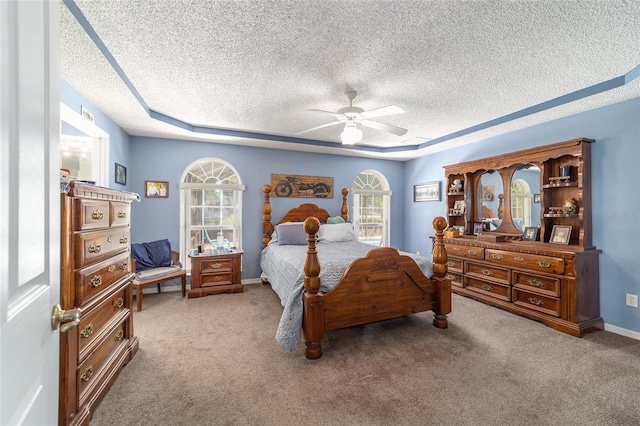 bedroom featuring a textured ceiling, multiple windows, and carpet