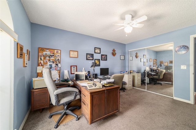 office with ceiling fan, light colored carpet, and a textured ceiling