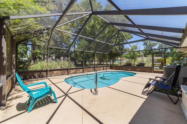 outdoor pool with central AC, glass enclosure, and a patio area