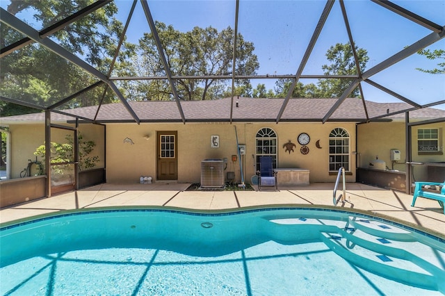 pool featuring a lanai, a patio, and central AC