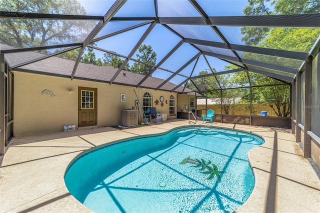 view of pool featuring central AC, fence, glass enclosure, a patio, and a fenced in pool