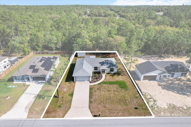 birds eye view of property with a wooded view