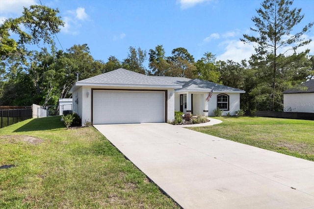 ranch-style house featuring an attached garage, concrete driveway, a front lawn, and fence