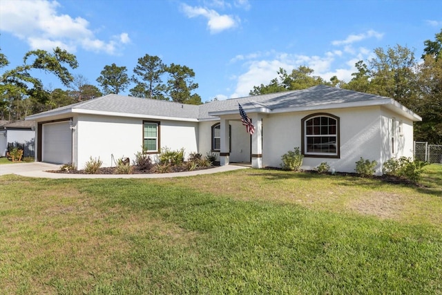 ranch-style home featuring a garage, stucco siding, a front yard, and concrete driveway