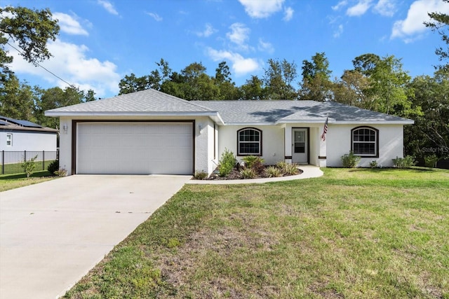 ranch-style house featuring driveway, an attached garage, fence, a front yard, and stucco siding