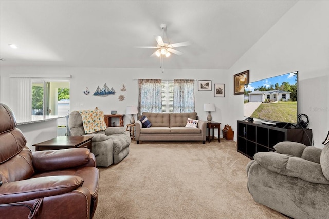 living area featuring lofted ceiling, light carpet, and a ceiling fan