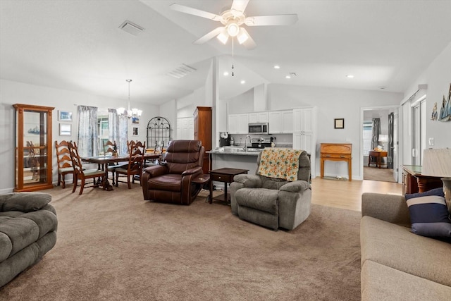 living area with recessed lighting, lofted ceiling, visible vents, light colored carpet, and ceiling fan with notable chandelier