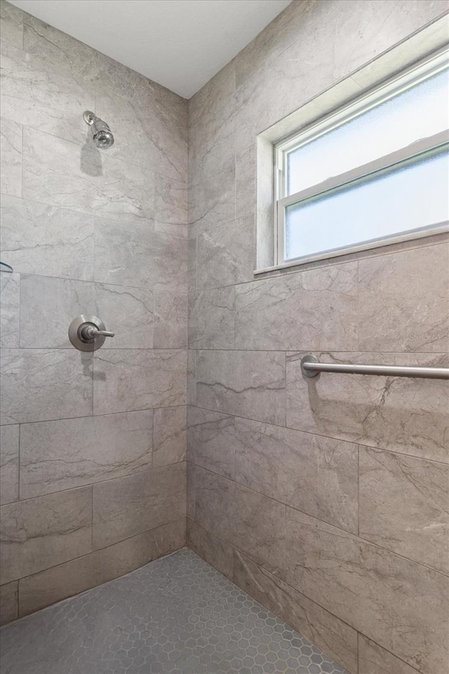 bathroom with tiled shower
