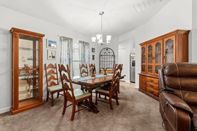 dining area featuring a chandelier, baseboards, and light carpet