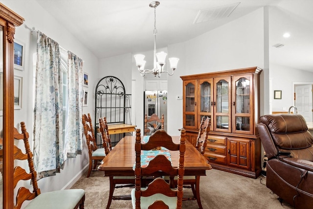 dining room with vaulted ceiling, visible vents, light colored carpet, and an inviting chandelier