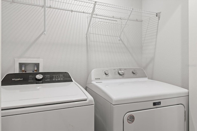 laundry area with washer and clothes dryer and laundry area