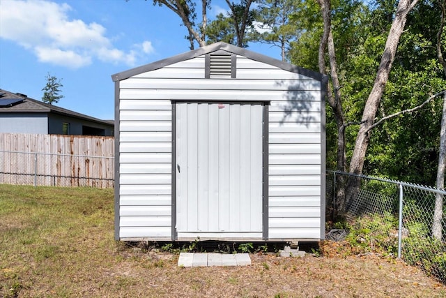 view of shed featuring a fenced backyard