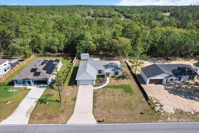 birds eye view of property with a forest view