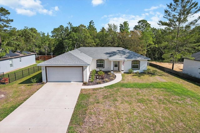 ranch-style home featuring a front lawn, driveway, fence, a garage, and roof with shingles