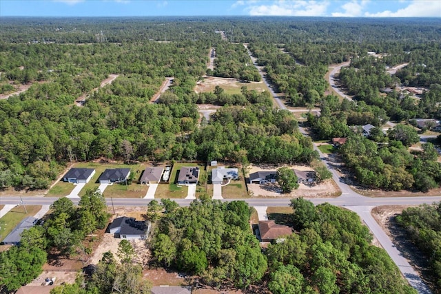 birds eye view of property featuring a wooded view
