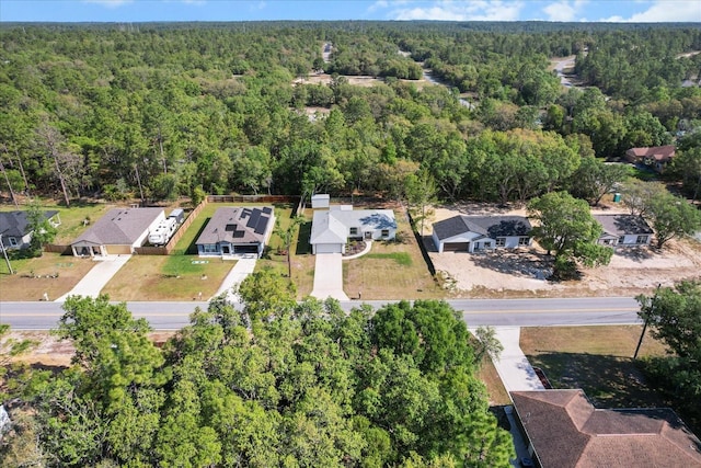 birds eye view of property with a view of trees and a residential view