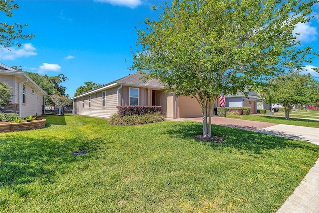 3918 NW 46th Ter, Ocala, FL 34482 - view of front of home featuring a garage, a front yard, and decorative driveway