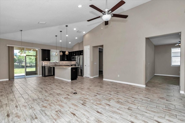 3918 NW 46th Ter, Ocala, FL 34482 - kitchen with ceiling fan, stainless steel appliances, light countertops, a kitchen island, and open floor plan