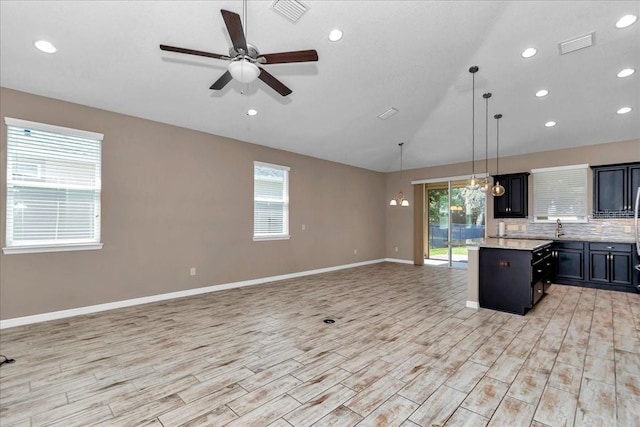 3918 NW 46th Ter, Ocala, FL 34482 - kitchen with visible vents, a ceiling fan, open floor plan, and vaulted ceiling