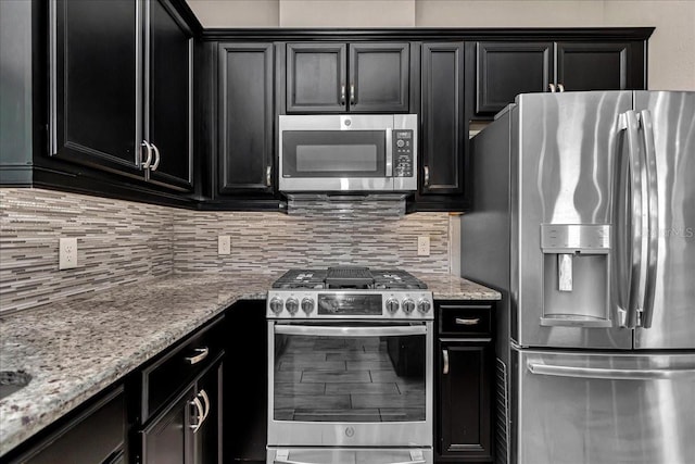 3918 NW 46th Ter, Ocala, FL 34482 - kitchen featuring dark cabinets, light stone counters, stainless steel appliances, and tasteful backsplash