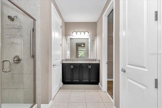 3918 NW 46th Ter, Ocala, FL 34482 - bathroom featuring baseboards, tile patterned flooring, a shower stall, and a spacious closet