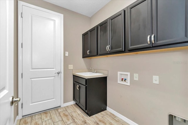 3918 NW 46th Ter, Ocala, FL 34482 - washroom with hookup for a washing machine, a sink, cabinet space, and baseboards