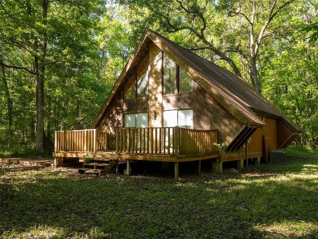 11420 NW 110th Ave, Reddick, FL 32686 - rear view of house with a wooded view, a wooden deck, and cooling unit