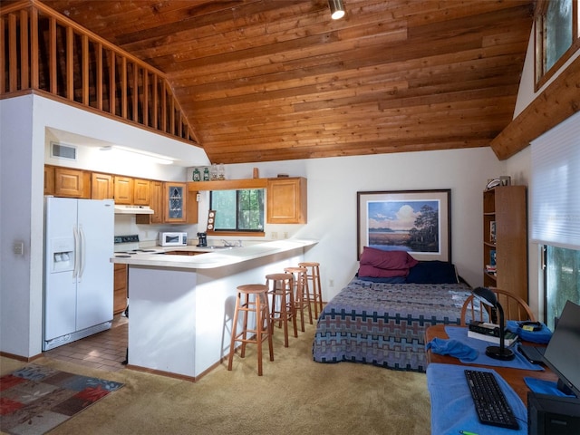 11420 NW 110th Ave, Reddick, FL 32686 - kitchen with wood ceiling, white fridge with ice dispenser, visible vents, under cabinet range hood, and a peninsula