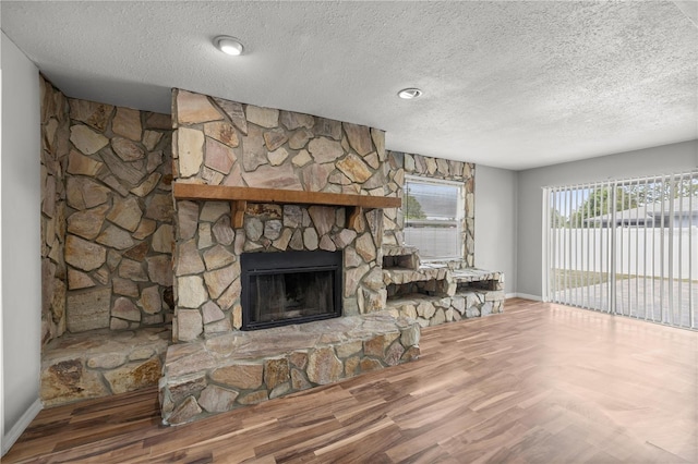15044 SW 35th Avenue Rd, Ocala, FL 34473 - unfurnished living room with a textured ceiling, a fireplace, and baseboards