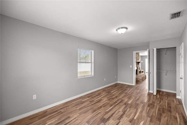15044 SW 35th Avenue Rd, Ocala, FL 34473 - unfurnished bedroom with baseboards, wood finished floors, visible vents, and a closet