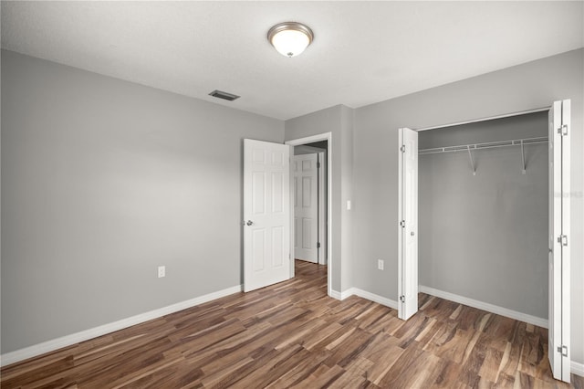 15044 SW 35th Avenue Rd, Ocala, FL 34473 - unfurnished bedroom featuring baseboards, wood finished floors, visible vents, and a closet
