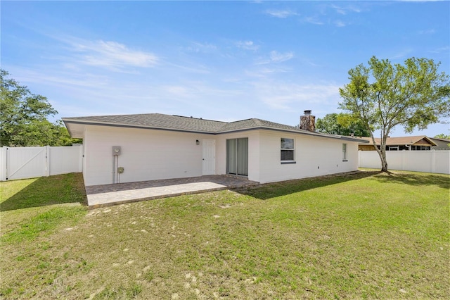 15044 SW 35th Avenue Rd, Ocala, FL 34473 - back of property with a gate, a lawn, a fenced backyard, and a patio