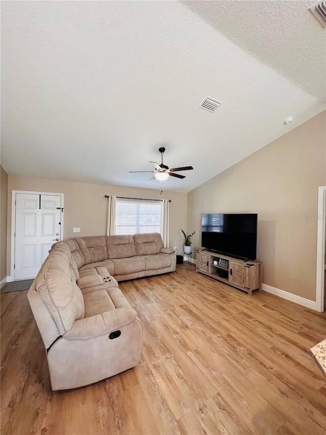 living room featuring baseboards, wood finished floors, and visible vents
