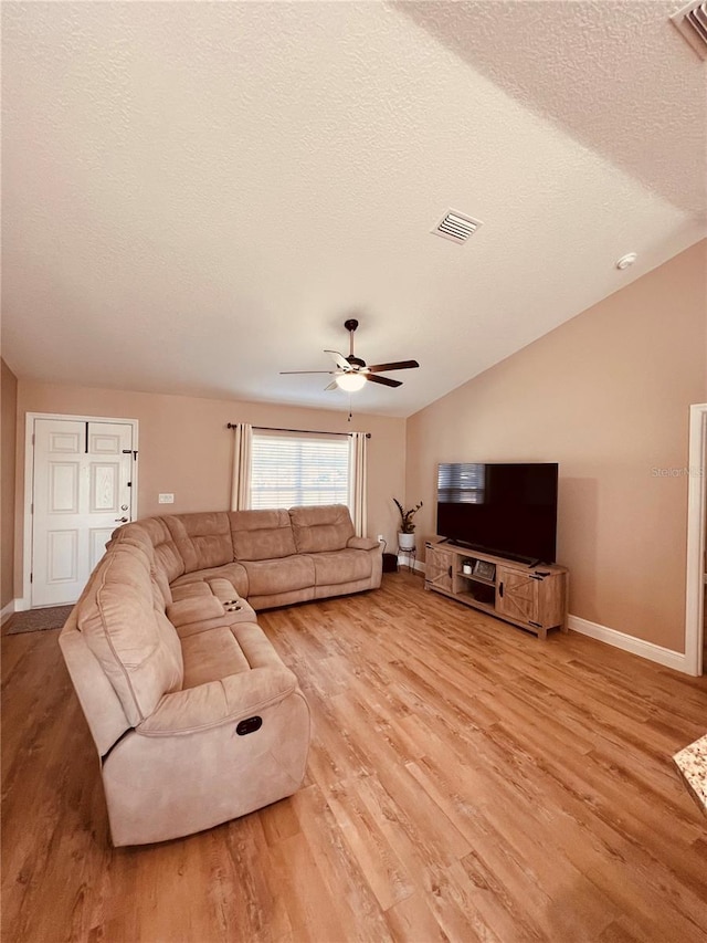 living area with light wood finished floors, baseboards, and visible vents